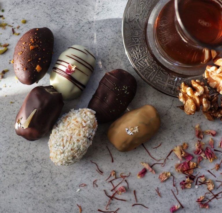 Arabic tea and chocolate covered and filled dates with roasted nuts and spices such as saffron and rose petals