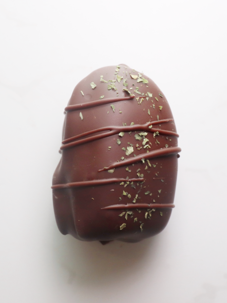 dark chocolate coated date filled with a mint crunch, drizzled in dark chocolate and finished off with Jordanian mint leaf