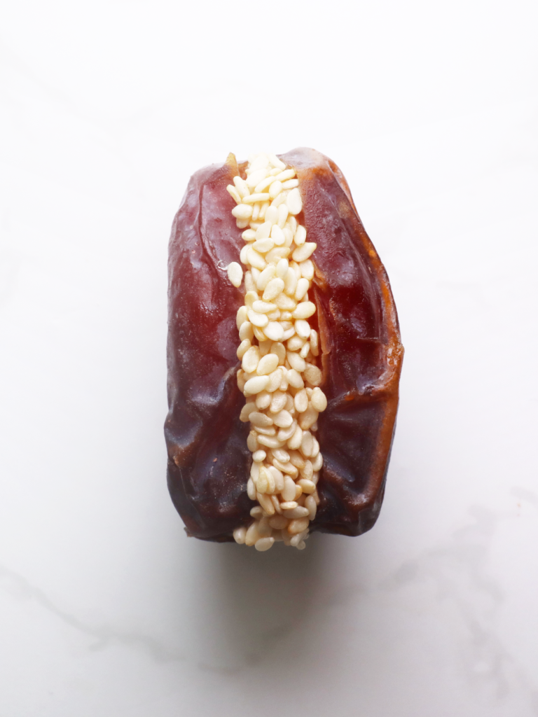 date filled with an exotic mis of golden honey and sesame seeds