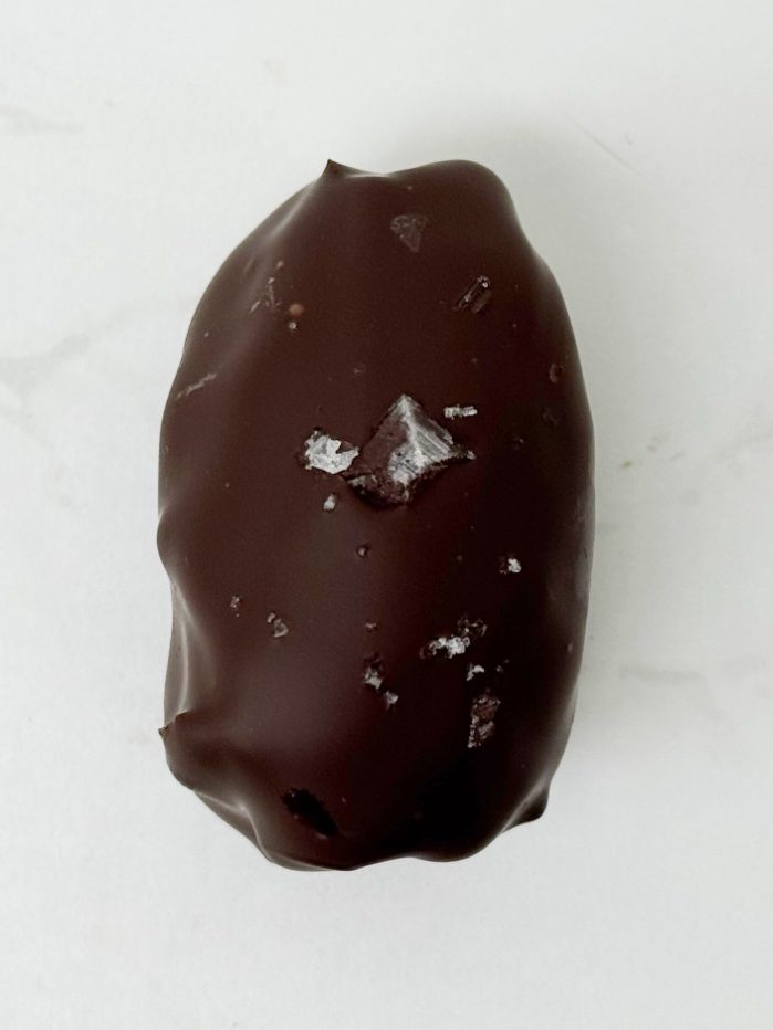 80% cocoa covered date filled with rich strawberry pate de fruits and topped off with a crispy quinoa and white chocolate blindfold - a limited edition for Valentines day!