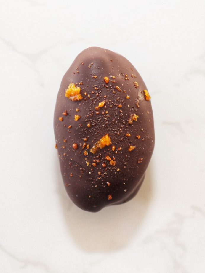 Dark chocolate coated date, filled with hazlenut praline and finished off with honeycomb