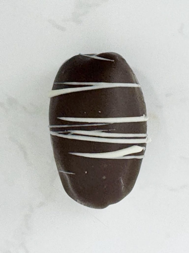 80% cocoa covered date filled with rich strawberry pate de fruits and topped off with a crispy quinoa and white chocolate blindfold - a limited edition for Valentines day!