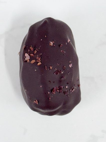 80% cocoa covered date filled with rich strawberry pate de fruits and topped off with a crispy quinoa and white chocolate blindfold - a limited edition for Valentines day!