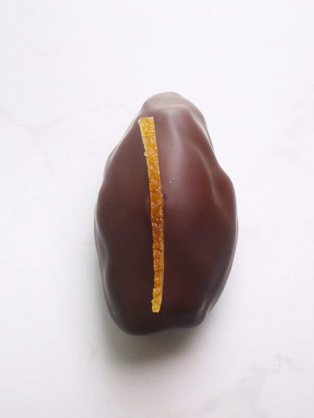 80% cocoa covered date filled with rich strawberry pate de fruits and topped off with a crispy quinoa and white chocolate blindfold - a limited edition for Valentines day!