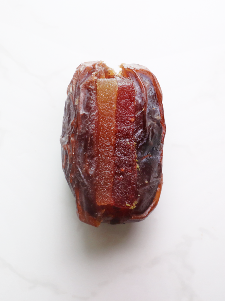 plump medjool date filled with our signature pate de fruits in a strawberry and peach flavour - a sweet sensation!